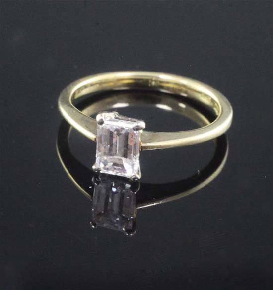 An 18ct gold and solitaire emerald cut diamond ring, size G.